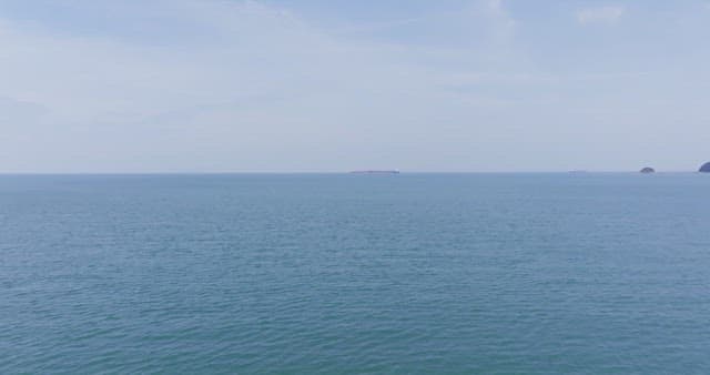 Vast ocean with a distant ship