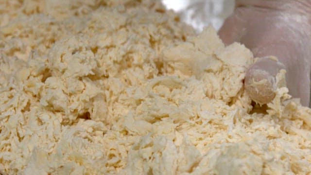 Mixing flour dough by hand in a bowl