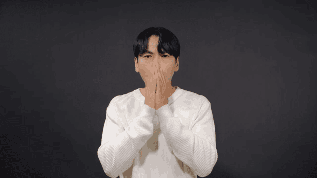 Man covering his mouth in surprise and expressing anxiety