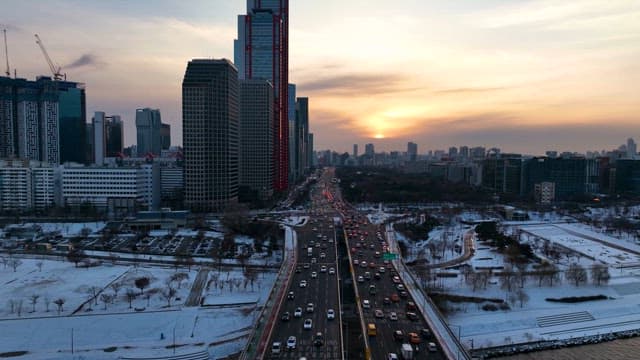 Winter Sunset over a Bustling City Road