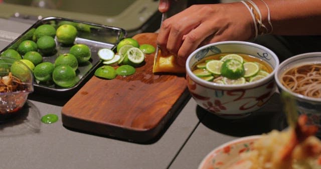 Bowls of Noodles and Lime Slices Prepared