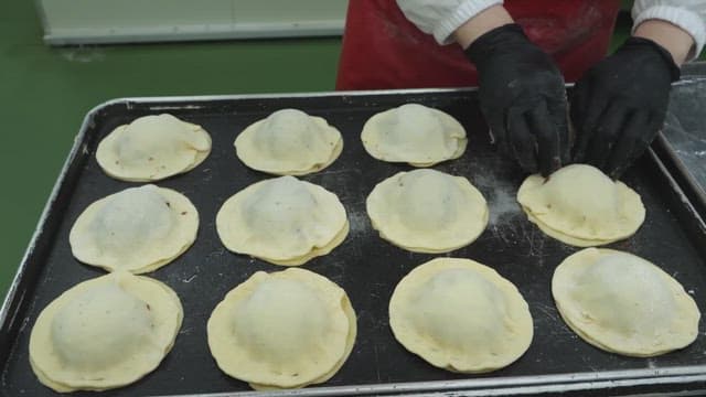 Preparing dough filled with bean paste in the kitchen