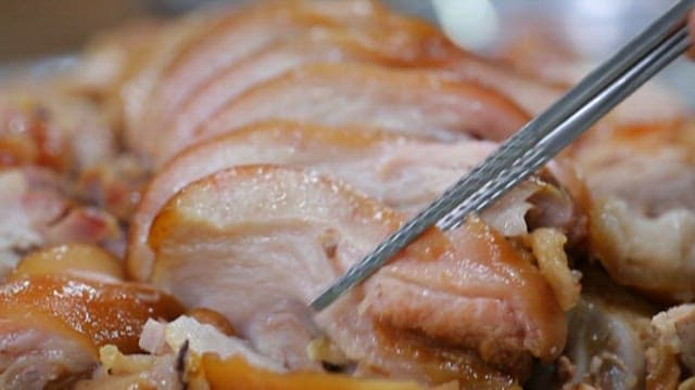 Shiny pig's feet picked up with chopsticks