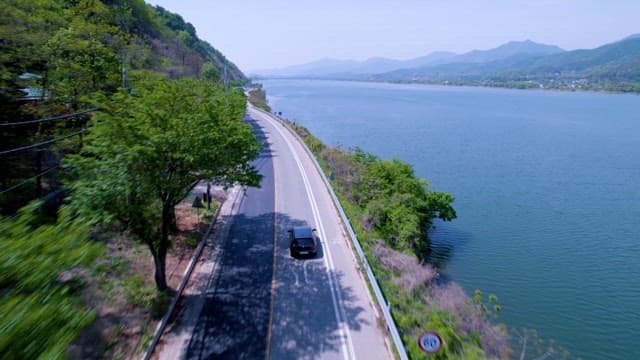 Scenic Road Alongside a Lake