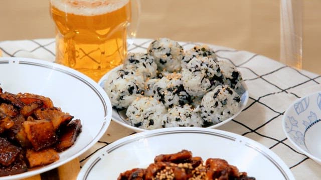 Close-up of Korean meal with rice balls and beer