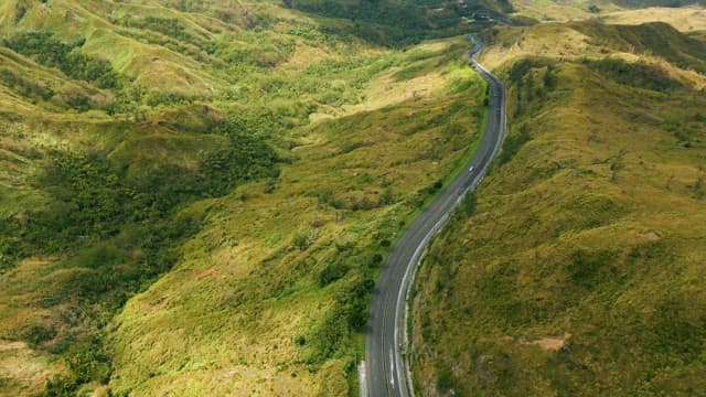 Winding Road Through Lush Green Hills