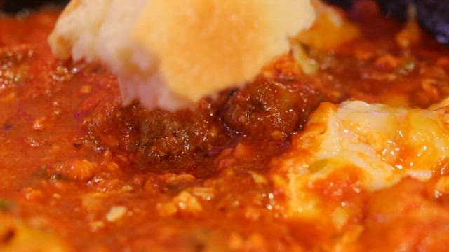 Bread dipped in beef kofta sauce