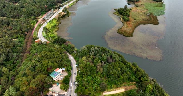 Winding road by a serene lake