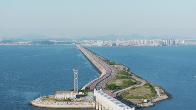 Long bridge connecting to a city skyline