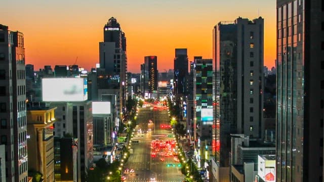 Colorful Urban Night View with Illuminated Buildings and Road Lights