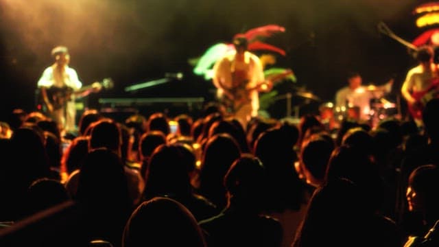 Band performance on stage at a stagel with a lot of audience