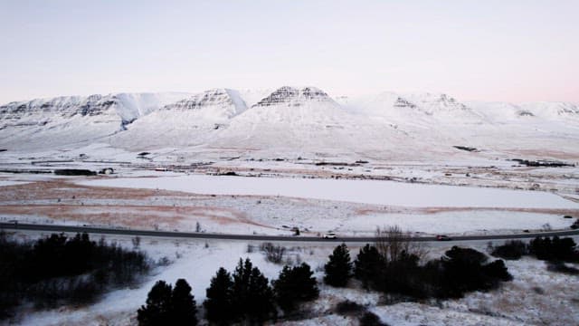 Snowy mountains and road with cars