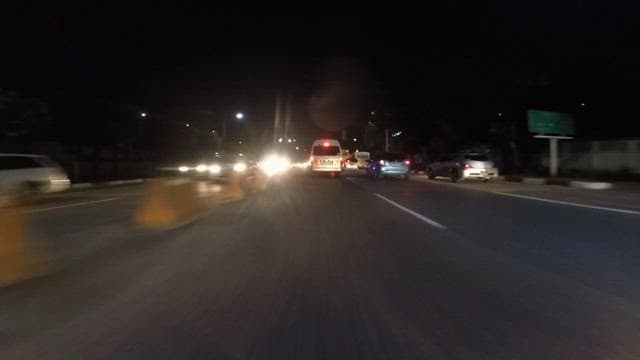 Night Drive Through a Busy City Street