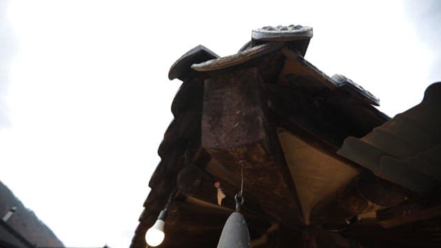 Traditional Korean roof with hanging wind chime