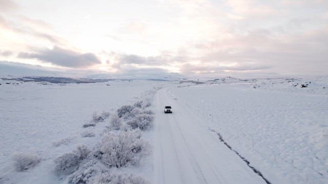 Car driving through a snowy landscape