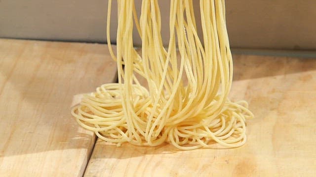 Pasta being extruded from a machine