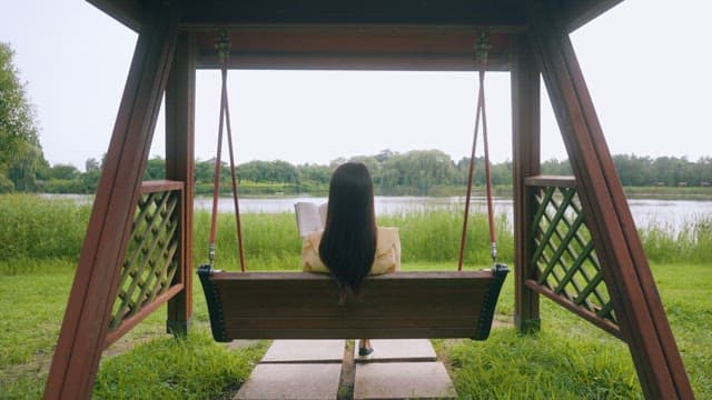 Woman Enjoying a Peaceful Read in the Park