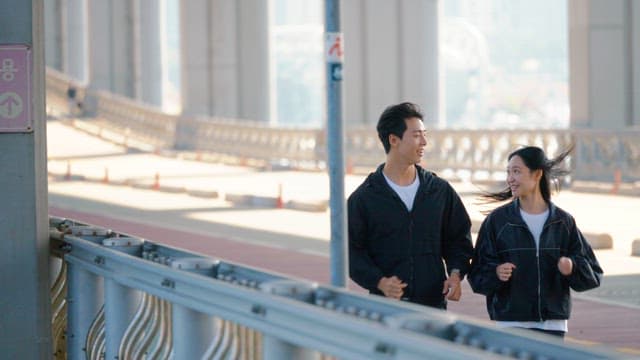Couple jogging on a jamsu bridge