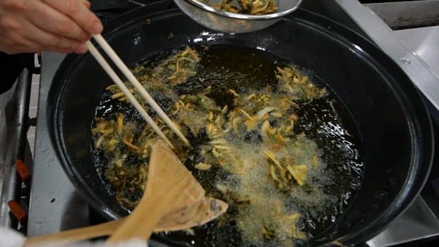 Sweet potato fritters frying in hot oil
