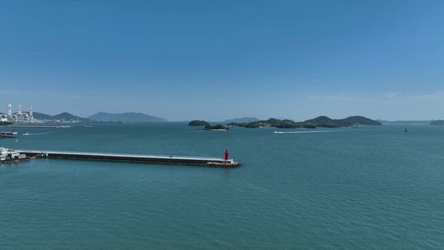 Calm sea with distant islands and a lighthouse