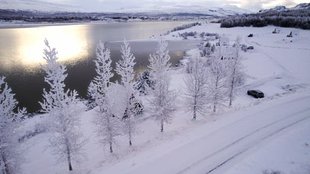 Snow-covered landscape with a frozen lake