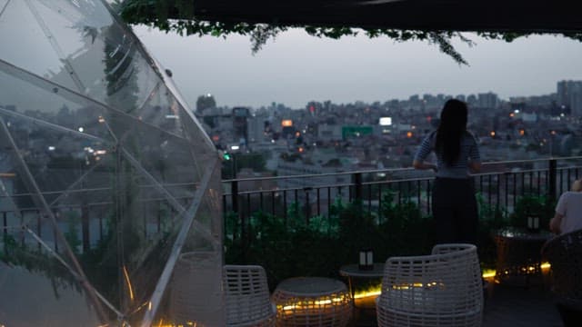 Two women looking at the city view from the rooftop