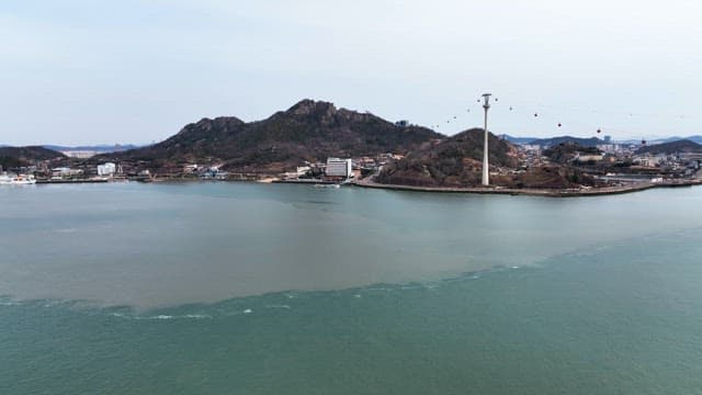 Coastal town with cable cars and mountains
