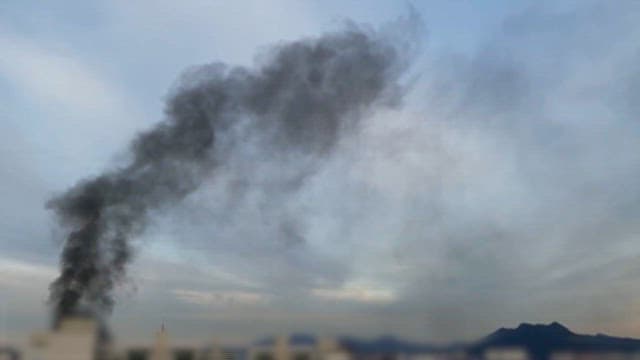 Black smoke rising from the fire scene