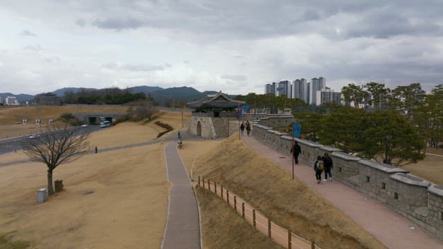 Aerial view of a historic gate of Hwaseong Fortress and cityscape