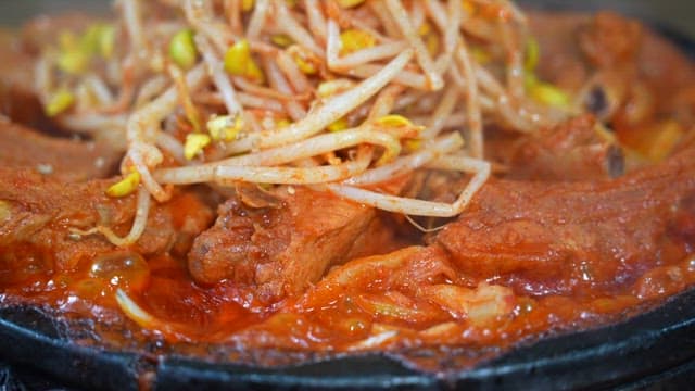 Hot and spicy pork ribs and bean sprouts being cooked