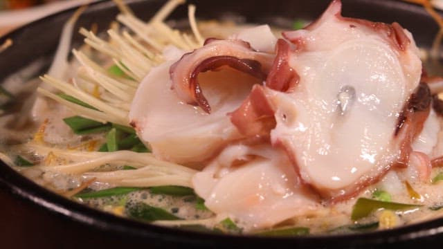 Bean sprout and rice soup with octopus served in a hot stone pot