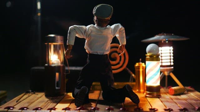 Puppet placed among vintage props on a wooden table