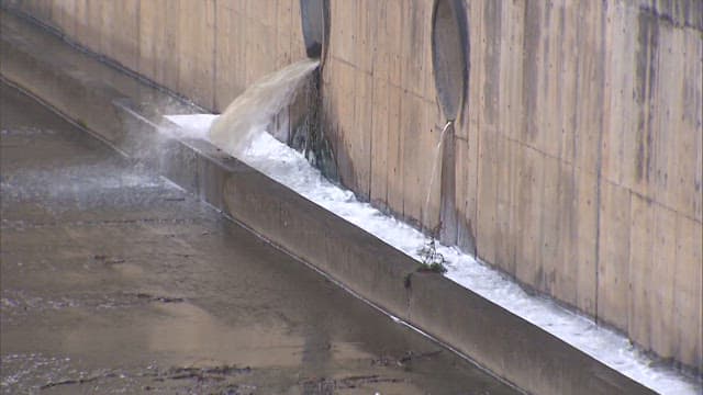 Water exiting from drain in concrete wall