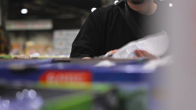 Person handling grapes in a market