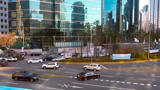 Bustling City Intersection and Sparkling Buildings at Dusk