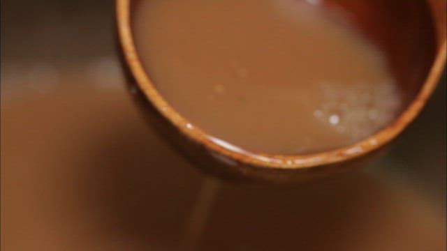 Dark golgamju poured into a traditional jar