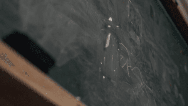 Close-up View of a Chalkboard and Eraser