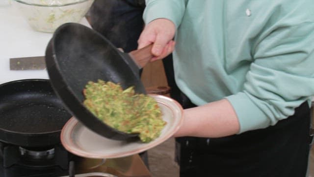 Plating deliciously cooked zucchini pancakes on a plate