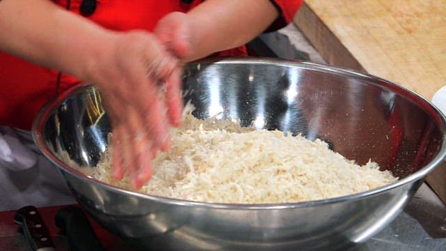 In a large bowl, coating the meat in the breadcrumbs