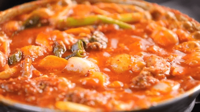 Spicy braised ribs boiling on the gas stove