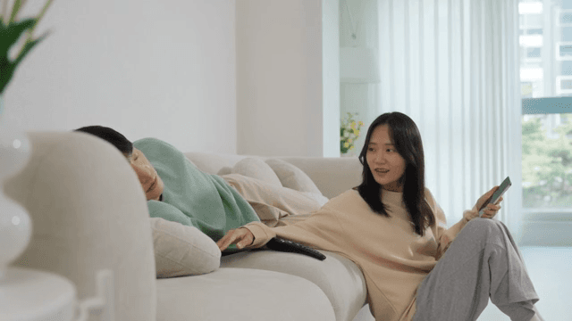 Two People Relaxing in a Bright Living Room