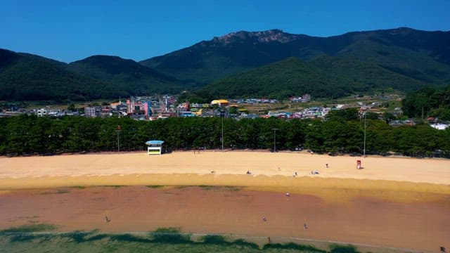 Coastal Town by the Sandy Beach and Mountains