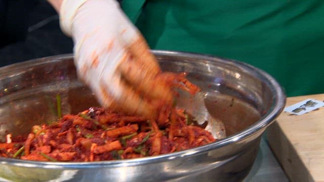 Sliced radish kimchi on cabbage leaves