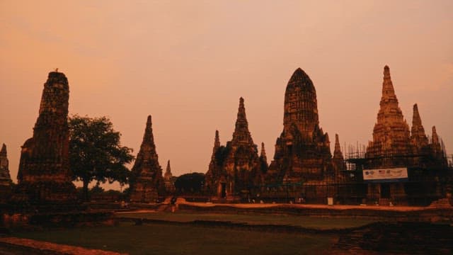 Panoramic view of a Thai Buddhist temple illuminated from dusk to night