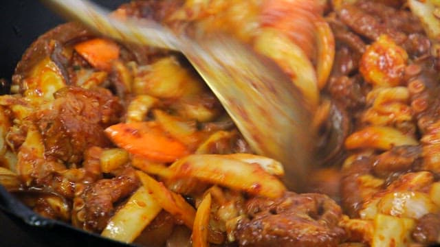 Spicy stir-fried octopus being cooked