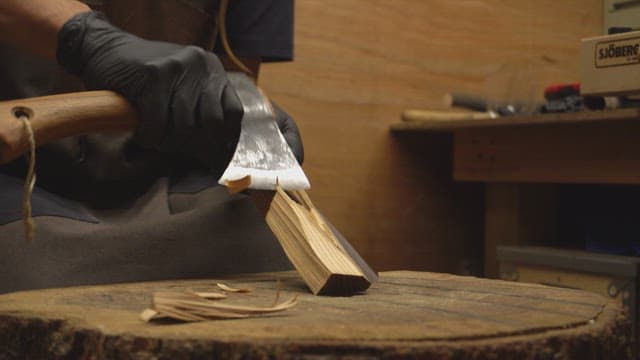Craftsman shaping wood with an axe