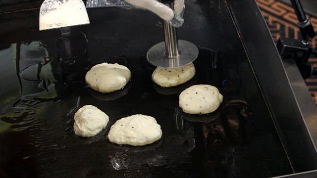 Korean hotteok cooking on a griddle