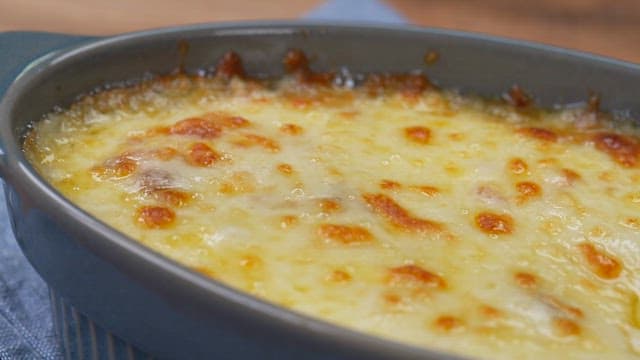 Spoonful of hot cheesy crab gratin