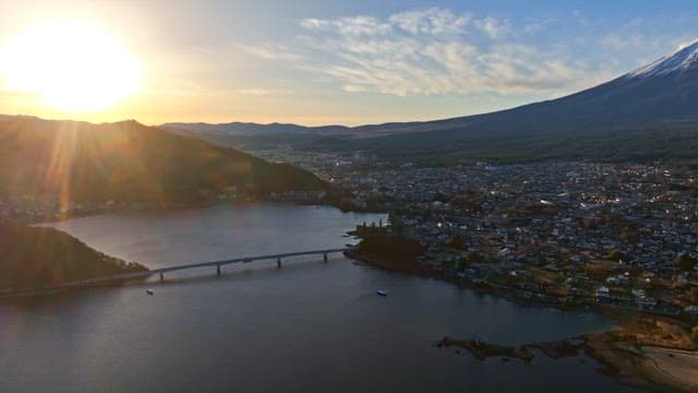 Serene lake with a city and Mount Fuji