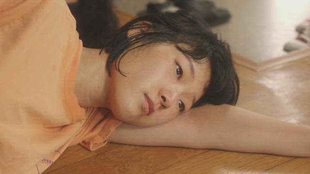 Woman lying on the floor and sweating